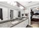 Elegant bathroom with double granite vanity, white cabinetry, and adjacent access to the bedroom at 1933 Tara Trl, Lancaster, SC 29720