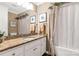 Charming bathroom with granite countertop, framed art, and elegant curtained shower at 1933 Tara Trl, Lancaster, SC 29720