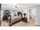 Serene bedroom with a four-poster bed, dark wood furniture, and large windows with natural light at 1933 Tara Trl, Lancaster, SC 29720