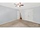 Comfortable bedroom offers neutral carpet and trim, a ceiling fan, and double closets at 1933 Tara Trl, Lancaster, SC 29720