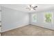 Cozy bedroom features neutral carpet, a ceiling fan, and lots of natural light at 1933 Tara Trl, Lancaster, SC 29720