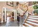Elegant foyer with hardwood stairs, slate floors, and classic architectural details at 1933 Tara Trl, Lancaster, SC 29720