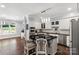 Modern kitchen with a black island, sleek appliances, granite countertops, and stylish bar stools at 1933 Tara Trl, Lancaster, SC 29720