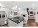 Elegant kitchen with an island cooktop, stylish lighting and stainless steel refrigerator at 1933 Tara Trl, Lancaster, SC 29720