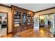 Elegant library featuring custom built-in bookshelves, hardwood floors, and abundant storage space at 1933 Tara Trl, Lancaster, SC 29720