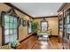 Cozy sitting room with hardwood floors, decorative curtains, and built-in shelving at 1933 Tara Trl, Lancaster, SC 29720