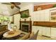 Relaxing outdoor patio with fireplace, TV, kitchenette, and comfortable seating area at 1933 Tara Trl, Lancaster, SC 29720