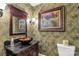 Unique powder room with decorative wallpaper, a vessel sink, and ornate mirror at 1933 Tara Trl, Lancaster, SC 29720