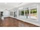 Bright sun room featuring hardwood floors and large windows with a view of the backyard pool at 1933 Tara Trl, Lancaster, SC 29720