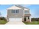 Charming two-story home with stone accents, a white garage door, and well-maintained landscaping at 219 Parker Claire Ln, Kings Mountain, NC 28086