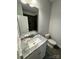 The spacious bathroom offers a granite countertop and tiled shower/tub at 219 Pine St, Rockwell, NC 28138