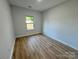 This bright bedroom includes wood-look floors and a window providing natural light at 219 Pine St, Rockwell, NC 28138