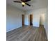 This spacious bedroom features modern wood-look floors, ceiling fan, and access to the bath at 219 Pine St, Rockwell, NC 28138