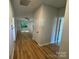 Bright hallway with hardwood flooring leading into a naturally lit living space at 219 Pine St, Rockwell, NC 28138