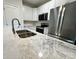 Modern kitchen featuring stainless steel appliances, white cabinets, and marble countertops at 219 Pine St, Rockwell, NC 28138