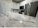 Modern kitchen featuring stainless steel appliances, white cabinets, and marble countertops at 219 Pine St, Rockwell, NC 28138