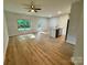 Bright, open-concept living room featuring wood-look flooring, kitchen island and natural light at 219 Pine St, Rockwell, NC 28138