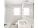 Bright bathroom with white tiles, tub, and a large mirror over the sink at 2722 Eastway Dr, Charlotte, NC 28205