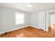 Simple bedroom with hardwood floors and natural light from a bright window at 2722 Eastway Dr, Charlotte, NC 28205