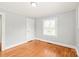 Cozy bedroom with hardwood floors, a closet, and a bright window at 2722 Eastway Dr, Charlotte, NC 28205