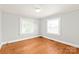 Bright, airy bedroom featuring hardwood floors and two sunlit windows at 2722 Eastway Dr, Charlotte, NC 28205