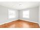 Bedroom featuring hardwood floors, neutral walls, and natural light from two windows at 2722 Eastway Dr, Charlotte, NC 28205