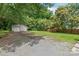 Exterior shot of a detached two car garage with an extra large parking pad and an expansive back yard at 2722 Eastway Dr, Charlotte, NC 28205