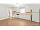 Kitchen featuring white cabinets, appliances, and hardwood-style floors at 2722 Eastway Dr, Charlotte, NC 28205