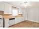 Efficient kitchen featuring all-white cabinets and sleek appliances at 2722 Eastway Dr, Charlotte, NC 28205