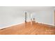 Spacious living room featuring beautiful hardwood floors and neutral paint at 2722 Eastway Dr, Charlotte, NC 28205