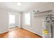 Utility room with water heater, shelves, and natural light at 2722 Eastway Dr, Charlotte, NC 28205