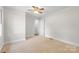 This is an unfurnished bedroom featuring neutral carpeting, a ceiling fan, and painted walls at 2800 Georgia Ave, Charlotte, NC 28205