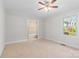 Bright bedroom featuring a ceiling fan, window, and an ensuite bathroom for added convenience at 2800 Georgia Ave, Charlotte, NC 28205