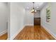 Cozy dining area with wood floors, a modern chandelier, and natural light from the window at 2800 Georgia Ave, Charlotte, NC 28205