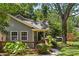 This charming home features a quaint front porch, well-maintained lawn, and mature trees at 2800 Georgia Ave, Charlotte, NC 28205