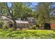 Charming two-story home featuring a covered front porch, mature trees, and well-maintained landscaping at 2800 Georgia Ave, Charlotte, NC 28205