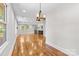 Open living space with hardwood floors, great natural light and kitchen in background at 2800 Georgia Ave, Charlotte, NC 28205