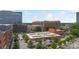 Urban cityscape featuring mixed-use buildings, office towers, parking garage, and green trees at 297 Mcdonald Ave, Charlotte, NC 28203