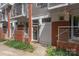 Charming townhouse exterior with brick accents, a small porch, and neat landscaping along the walkway at 297 Mcdonald Ave, Charlotte, NC 28203