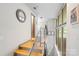 Bright hallway featuring wood floors and stainless steel handrails looking out of large grid windows at 297 Mcdonald Ave, Charlotte, NC 28203