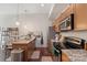 Well-equipped kitchen featuring stainless steel appliances, granite countertops, and a modern breakfast bar setup at 297 Mcdonald Ave, Charlotte, NC 28203