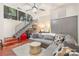 Contemporary living room features a gray sectional sofa and unique metallic coffee table beneath a modern ceiling fan at 297 Mcdonald Ave, Charlotte, NC 28203