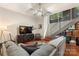 Stylish living room with a gray sectional sofa, modern TV, and staircase with metal railings at 297 Mcdonald Ave, Charlotte, NC 28203
