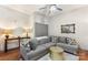 Cozy living space with a gray sectional, metallic table, and staircase, creating a modern and comfortable ambiance at 297 Mcdonald Ave, Charlotte, NC 28203