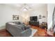 Inviting living room featuring a comfortable gray sofa, decorative accents, and a warm, well-lit atmosphere at 297 Mcdonald Ave, Charlotte, NC 28203