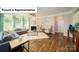 Spacious living room with hardwood floors, a fireplace, and large windows offering ample natural light at 3122 Spring Iris Dr, Denver, NC 28037