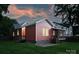 This is the rear exterior of a red home, complete with a back porch and patio at 3519 Card St, Charlotte, NC 28205