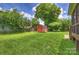 Expansive backyard featuring a well-maintained lawn and a charming red storage shed at 3519 Card St, Charlotte, NC 28205
