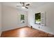 Bright bedroom with hardwood floors, ceiling fan, two windows with shutters and neutral wall paint at 3519 Card St, Charlotte, NC 28205