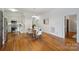 Open dining area with hardwood floors, and white walls, adjacent to the modern kitchen at 3519 Card St, Charlotte, NC 28205